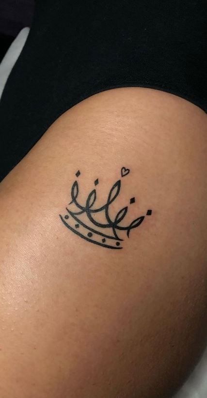 _ 18 Minimalist crown tattoo with heart detail on skin, representing royalty and elegance. | Sky Rye Design Minimalist crown tattoo with heart detail on skin, representing royalty and elegance.