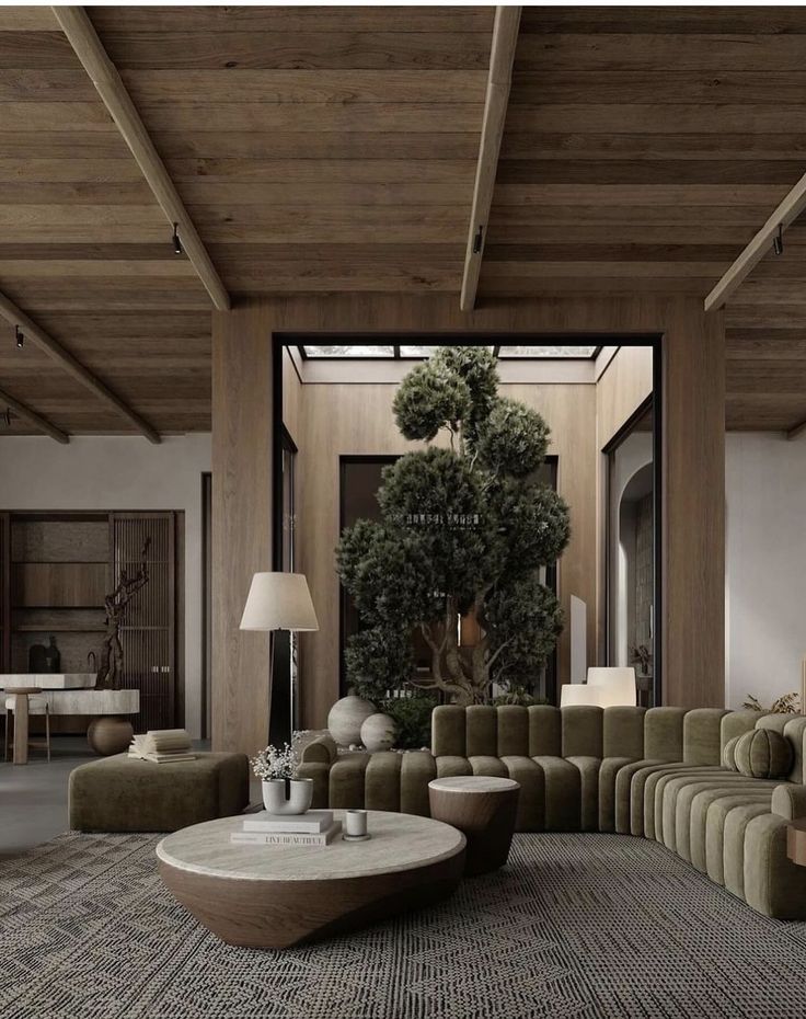 _ 19 Modern living room with green sofa, wooden ceiling, large indoor plant, and geometric coffee table. Cozy decor. | Sky Rye Design Modern living room with green sofa, wooden ceiling, large indoor plant, and geometric coffee table. Cozy decor.