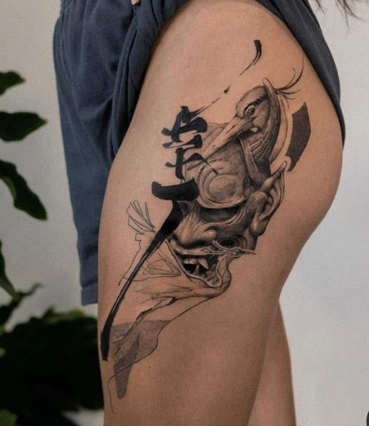 _ 19 Abstract tattoo on thigh featuring a blend of bird and face design with Japanese characters. | Sky Rye Design Abstract tattoo on thigh featuring a blend of bird and face design with Japanese characters.