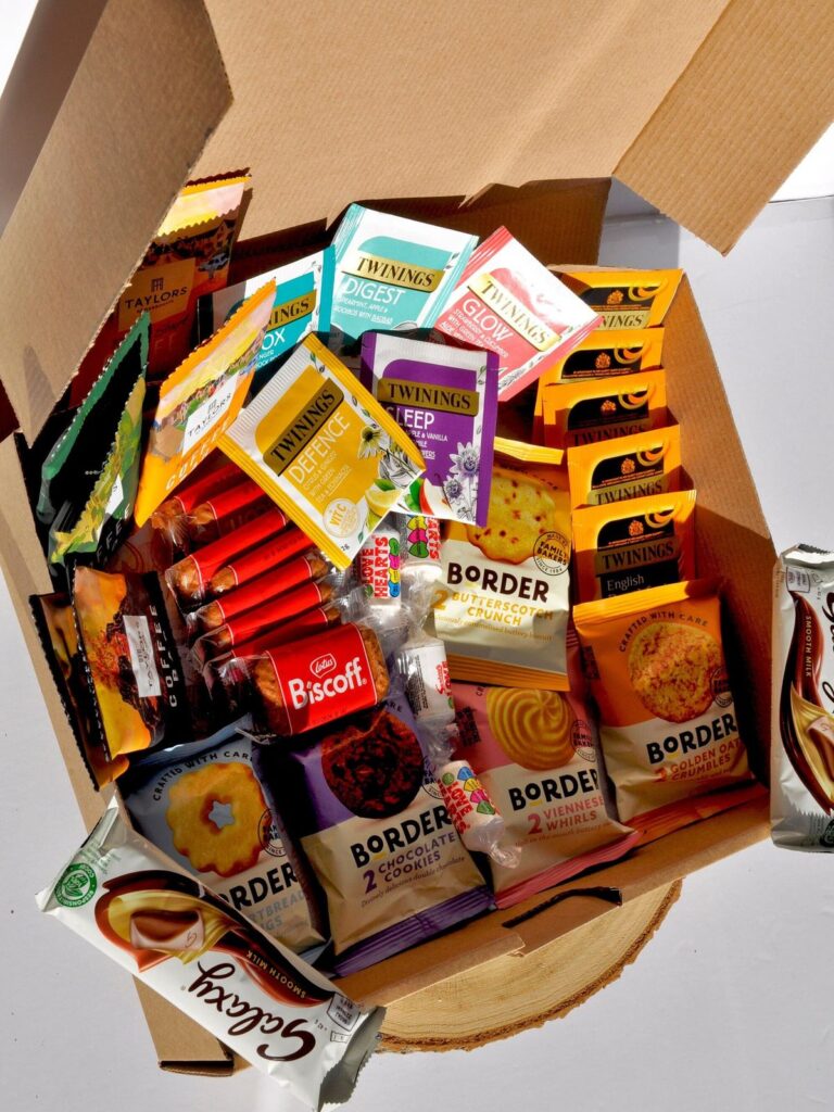 1e4cdd973b3431b303c4d5cc8e34066f Box of assorted tea packets and biscuits, featuring Twinings and Border brands, perfect for a cozy tea time experience. | Sky Rye Design Box of assorted tea packets and biscuits, featuring Twinings and Border brands, perfect for a cozy tea time experience.