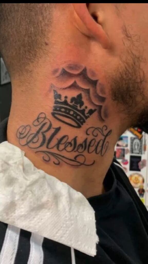 _ 20 Neck tattoo with the word Blessed and a crown design, showcasing intricate font and shading work. | Sky Rye Design Neck tattoo with the word Blessed and a crown design, showcasing intricate font and shading work.