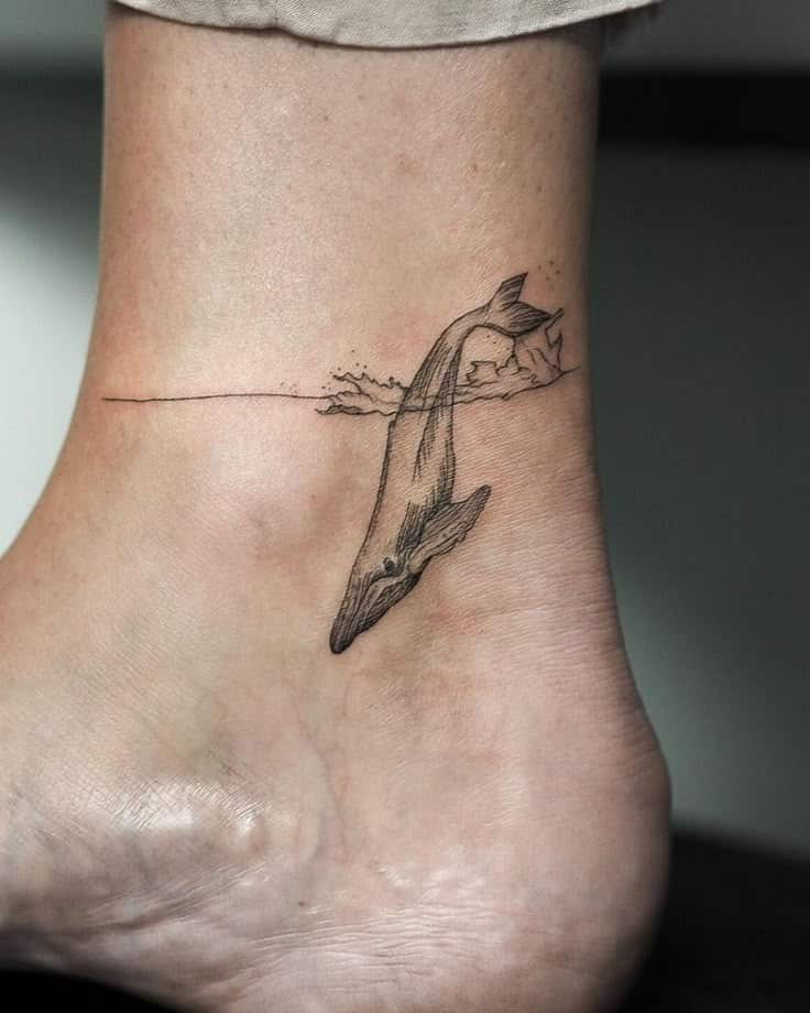 20+ Whale Tattoo Ideas for Ocean Enthusiasts Minimalist whale tattoo on ankle, mermaid-like design with waves, elegant line art. | Sky Rye Design Minimalist whale tattoo on ankle, mermaid-like design with waves, elegant line art.