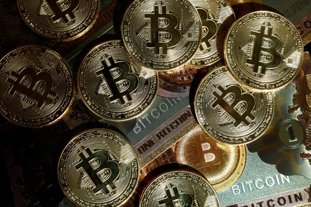 FILE PHOTO FILE PHOTO Illustration shows representations of cryptocurrency Bitcoin Pile of gold Bitcoin coins symbolizing cryptocurrency and digital currency investment. | Sky Rye Design Pile of gold Bitcoin coins symbolizing cryptocurrency and digital currency investment.