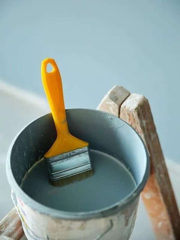 _ 22 Paintbrush in a paint can on a ladder, ready for use in home renovation or painting projects. | Sky Rye Design Paintbrush in a paint can on a ladder, ready for use in home renovation or painting projects.