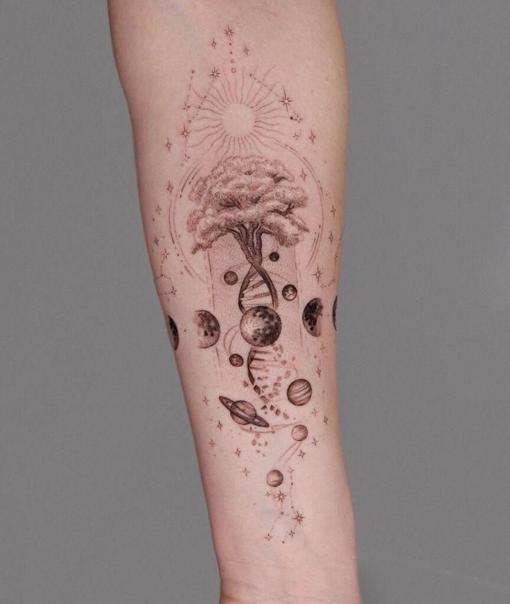 Tattoo design featuring a tree growing from DNA with celestial elements like planets and stars on an arm.