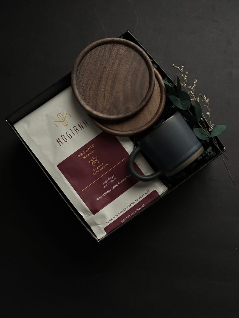 238689a1428a914bc5fe4e95ac8ee0c1 Coffee gift set with organic coffee, mug, wooden coasters, and greenery on a dark background. | Sky Rye Design Coffee gift set with organic coffee, mug, wooden coasters, and greenery on a dark background.
