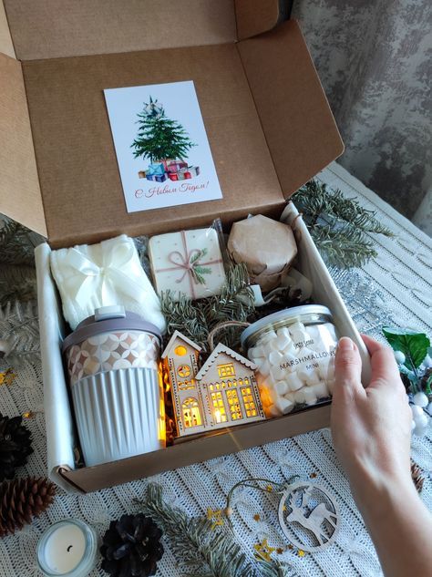 Gift box with candles, festive decorations, and marshmallows, perfect for a cozy holiday celebration.