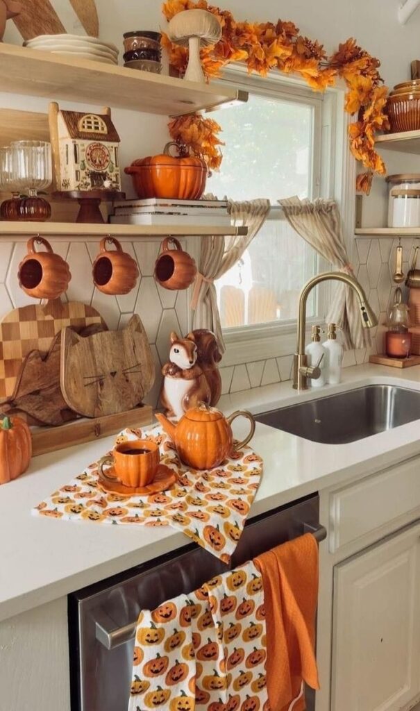 Cozy autumn kitchen with pumpkin decor, teapot, and festive fall theme near a sink and window.