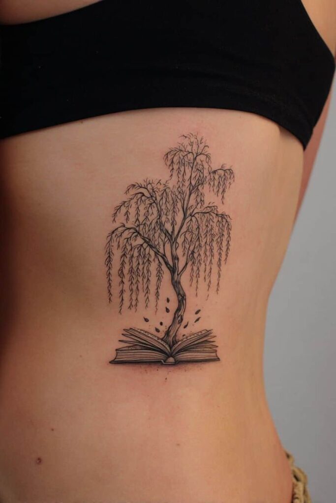 Tattoo of a tree growing from an open book on a person's side.