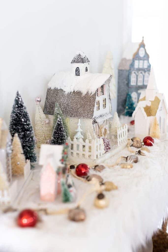 2720ff34a27918b94561818812f8cb31 Miniature snowy village scene with festive decorations and small Christmas trees on display. | Sky Rye Design Miniature snowy village scene with festive decorations and small Christmas trees on display.