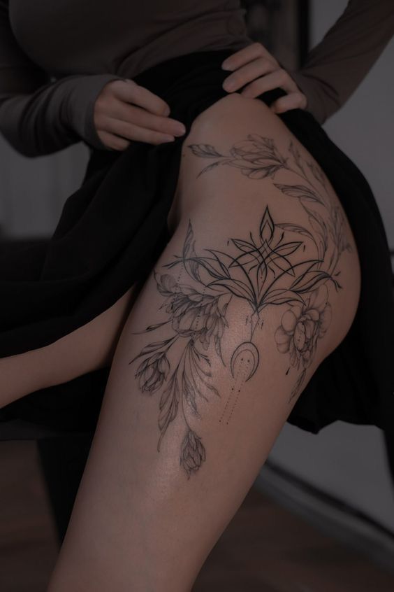 _ 28 Ornate floral thigh tattoo with geometric elements revealed under a dark skirt. | Sky Rye Design Ornate floral thigh tattoo with geometric elements revealed under a dark skirt.