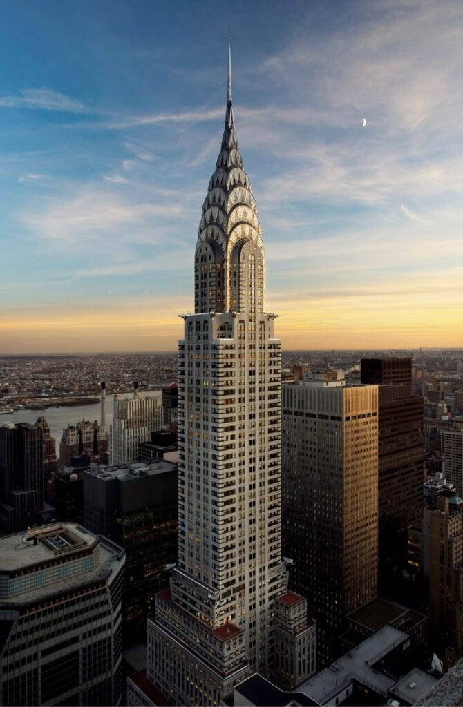 Iconic skyscraper against a sunset sky in New York City, displaying art deco architecture and urban skyline beauty.