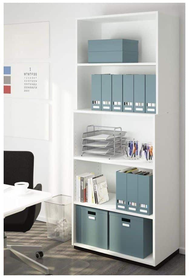 White office shelf with organized blue boxes and folders, alongside neatly stacked papers and books.