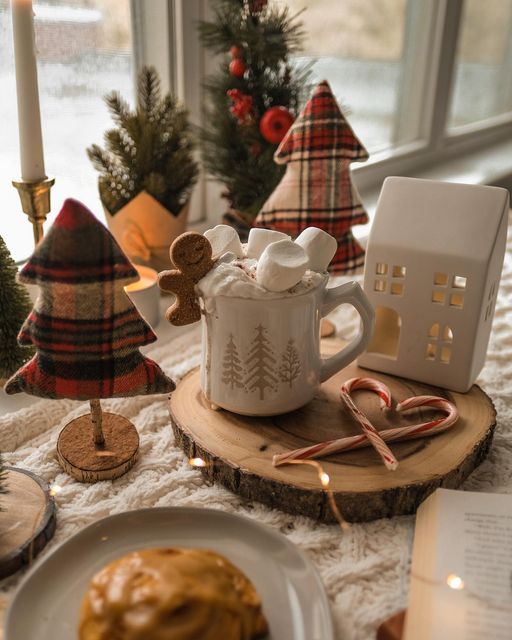 _ 3 Cozy winter scene with hot cocoa, marshmallows, gingerbread man, plaid trees, and candy canes on a wooden slab. | Sky Rye Design Cozy winter scene with hot cocoa, marshmallows, gingerbread man, plaid trees, and candy canes on a wooden slab.