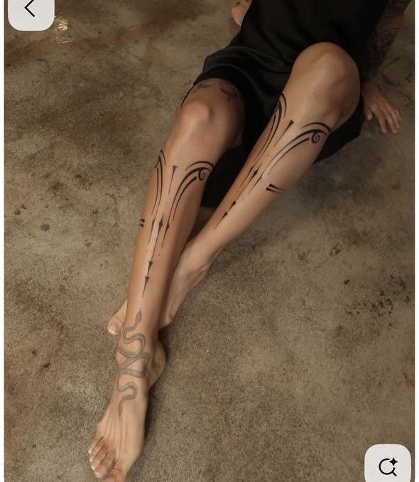 _ 3 Person with geometric and snake leg tattoos on a concrete floor. | Sky Rye Design Person with geometric and snake leg tattoos on a concrete floor.