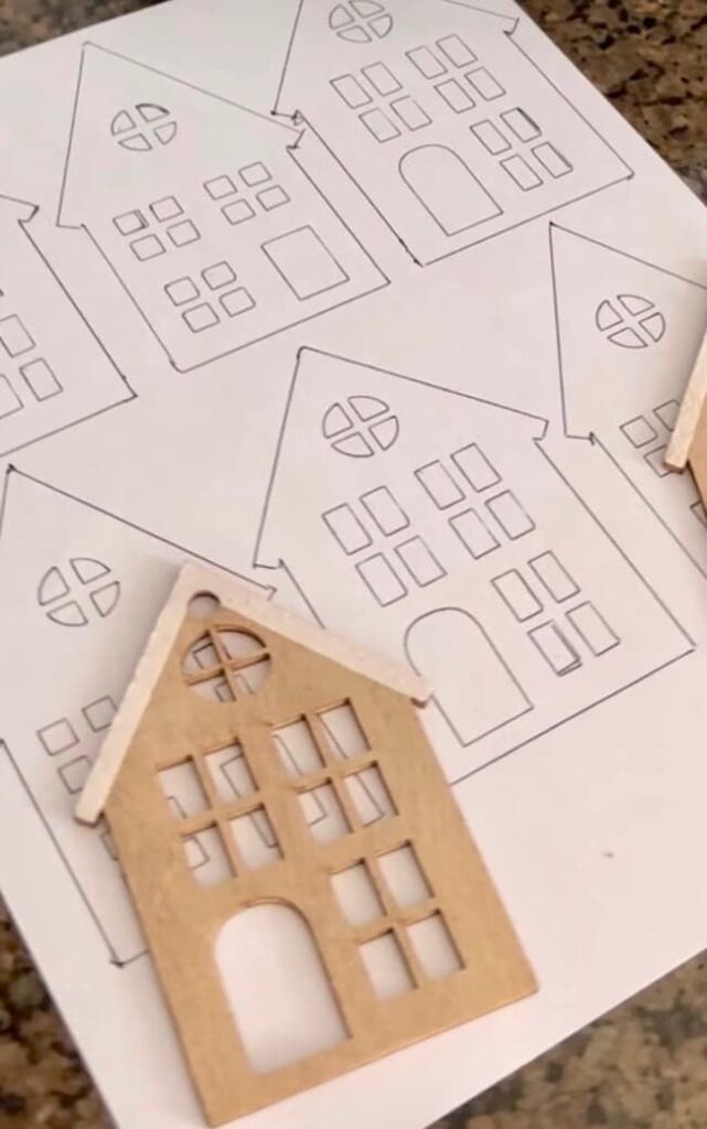 3183e9e54c5207213353d4378f38487e Wooden house template on paper for crafts, featuring cut-out windows and doors, perfect for DIY projects. | Sky Rye Design Wooden house template on paper for crafts, featuring cut-out windows and doors, perfect for DIY projects.