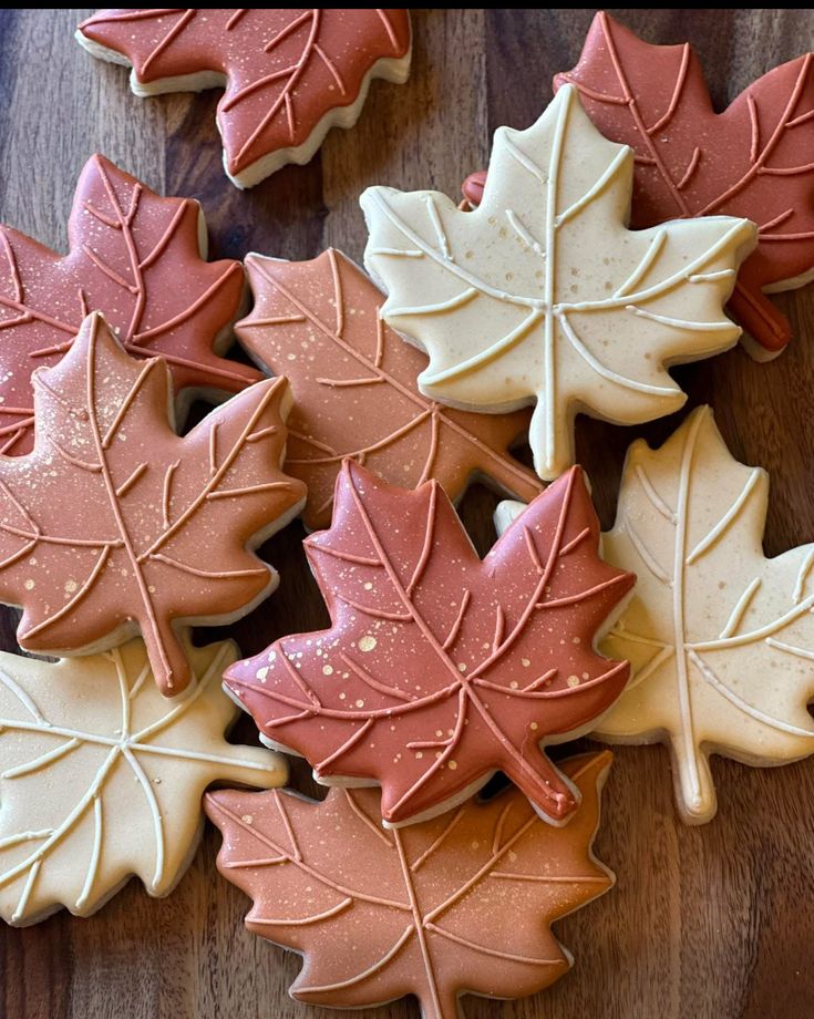 334d4d41-ddde-4bea-b32b-1042773c6af5 Autumn-themed leaf-shaped cookies in fall colors on a wooden surface, perfect for festive seasonal treats. | Sky Rye Design Autumn-themed leaf-shaped cookies in fall colors on a wooden surface, perfect for festive seasonal treats.