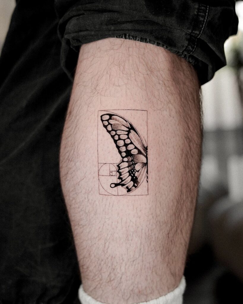 3607c8fdc0e87668cd71435d117e17ca Tattoo of a butterfly wing with geometric lines on a person's arm, showcasing intricate design and detail. | Sky Rye Design Tattoo of a butterfly wing with geometric lines on a person's arm, showcasing intricate design and detail.