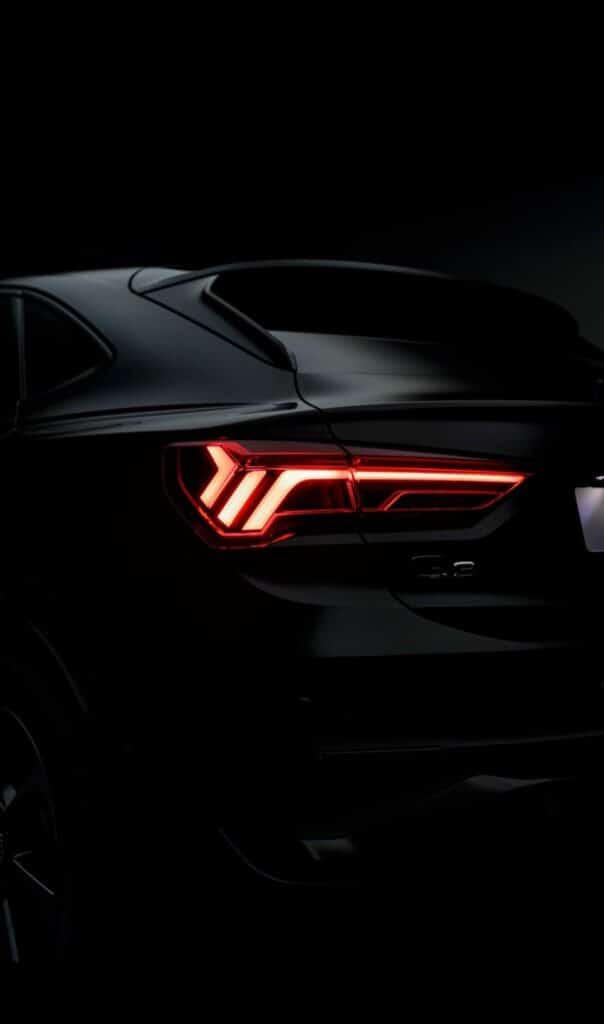 36381118c6674f80dbdf7db97a14602c Sleek dark car with illuminated red taillights at night, showcasing modern automotive design and luxury aesthetics. | Sky Rye Design Sleek dark car with illuminated red taillights at night, showcasing modern automotive design and luxury aesthetics.