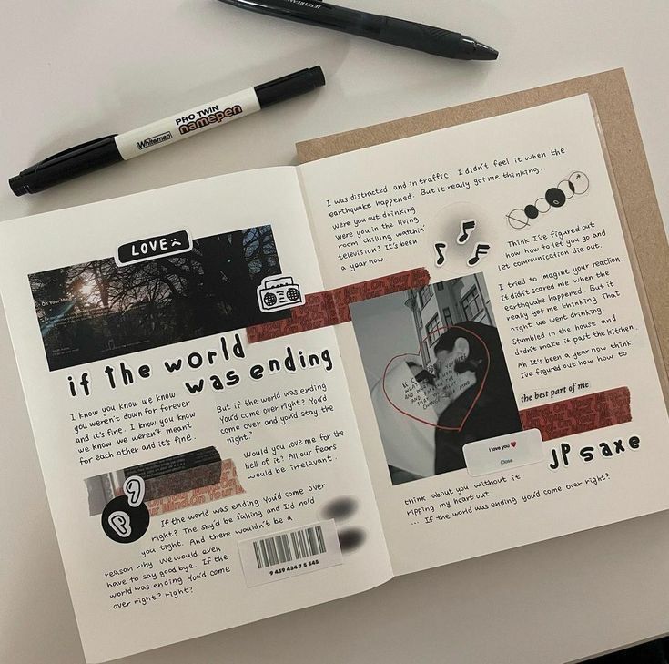 Scrapbook page with song lyrics, collages, and doodles, alongside two markers on a white table.