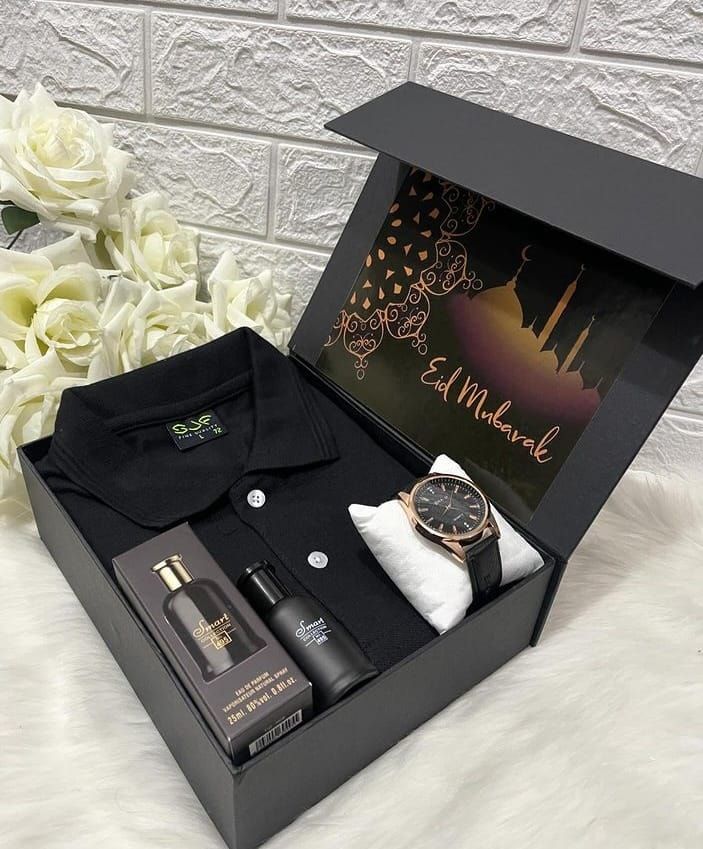 397278070ed6594cc536969e50eef3c0 Eid gift box with a black shirt, watch, perfume, and a greeting card, surrounded by white roses. | Sky Rye Design Eid gift box with a black shirt, watch, perfume, and a greeting card, surrounded by white roses.
