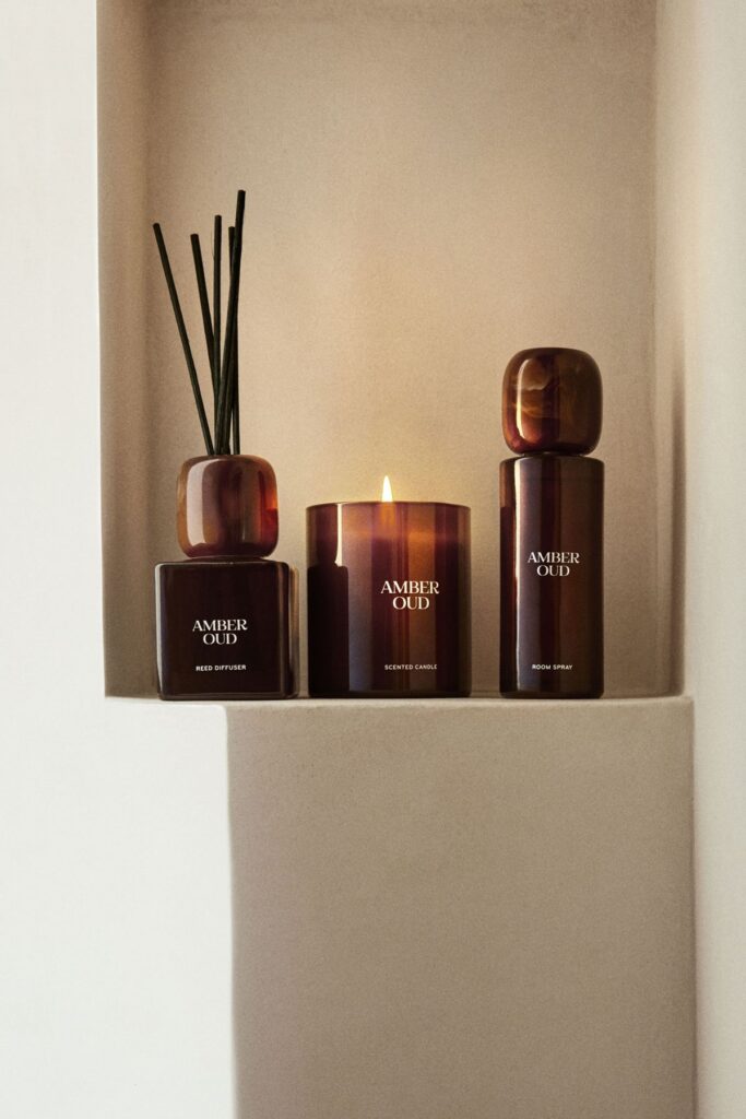3c5affd1f487dcedfe86e5378499b479 Amber Oud reed diffuser, scented candle, and room spray on a beige shelf for a cozy ambiance. | Sky Rye Design Amber Oud reed diffuser, scented candle, and room spray on a beige shelf for a cozy ambiance.