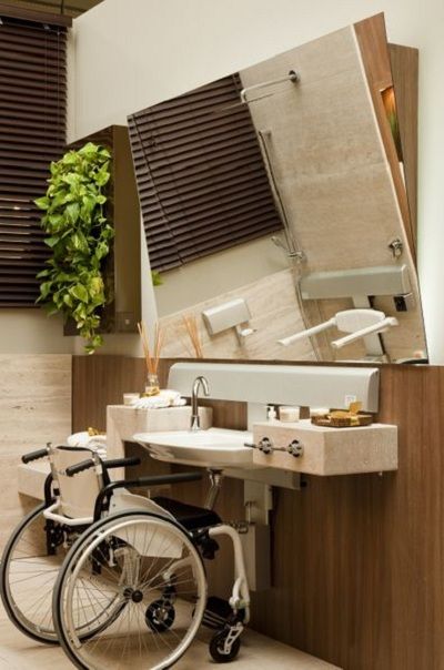 Accessible bathroom with modern design, featuring a wheelchair-friendly sink and a large mirror.