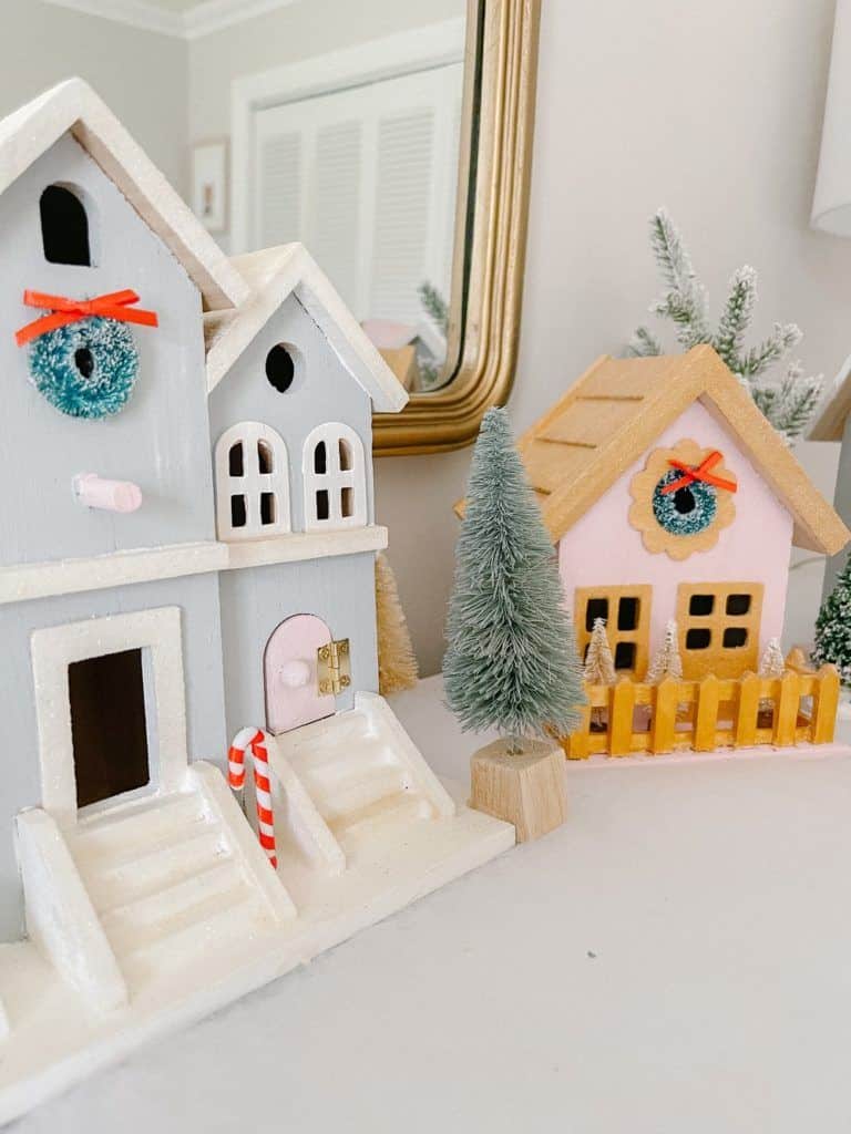 4755c4a0589d56eaa2bb60f2d77c8fa8 Miniature wooden houses adorned with wreaths and candy canes, nestled among small fir trees. Holiday decor scene. | Sky Rye Design Miniature wooden houses adorned with wreaths and candy canes, nestled among small fir trees. Holiday decor scene.