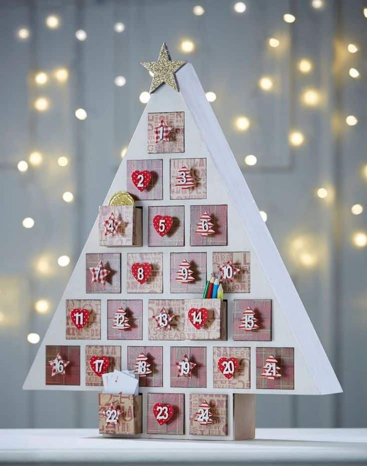 4cec6c21-4cd6-4828-ad7d-9e16f7e87a86 Christmas tree-shaped advent calendar with numbered drawers and a star topper, set against a backdrop of twinkling lights. | Sky Rye Design Christmas tree-shaped advent calendar with numbered drawers and a star topper, set against a backdrop of twinkling lights.