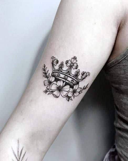 _ 5 Tattoo of an ornate crown with floral accents on an arm in grayscale. | Sky Rye Design Tattoo of an ornate crown with floral accents on an arm in grayscale.