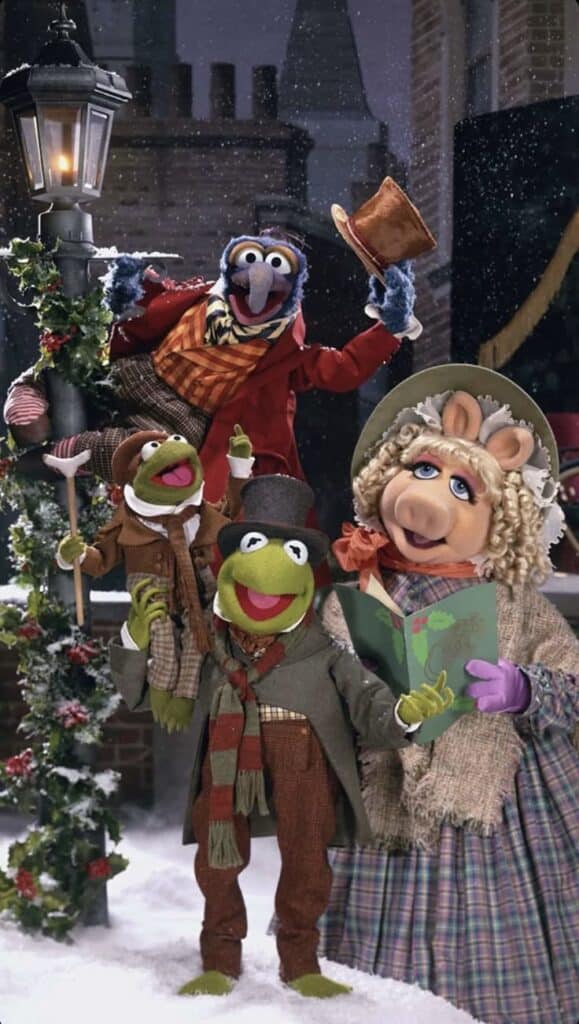 _ 5 Muppet characters dressed in Victorian attire, caroling in a snowy scene near a lamppost and festive decorations. | Sky Rye Design Muppet characters dressed in Victorian attire, caroling in a snowy scene near a lamppost and festive decorations.