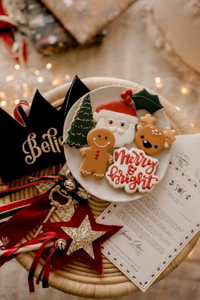 _ 5 Festive Christmas cookies with Santa, gingerbread, reindeer, and Merry & Bright on a plate with holiday decor. | Sky Rye Design Festive Christmas cookies with Santa, gingerbread, reindeer, and Merry & Bright on a plate with holiday decor.