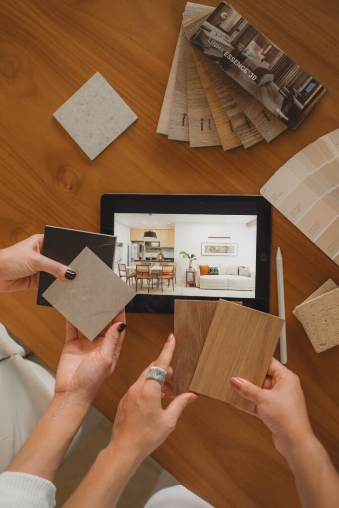 _ 5 Interior design planning with tablet, material samples, and color swatches on wooden table. | Sky Rye Design Interior design planning with tablet, material samples, and color swatches on wooden table.