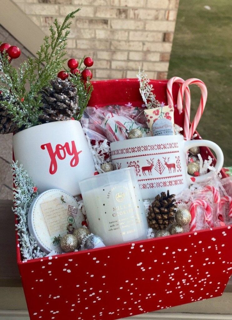 Festive holiday gift basket with mugs, candy canes, candle, and decorations in a red box perfect for Christmas cheer.