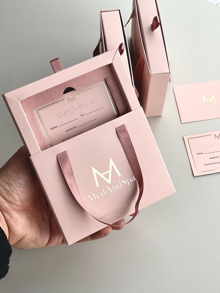Pink MedAndSpa gift card box with elegant ribbon, perfect for special occasions and luxury gifting experiences.
