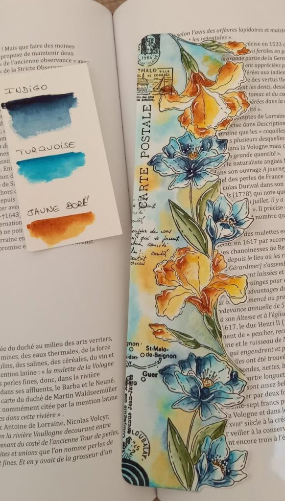 Colorful floral bookmark with paint palette between book pages.