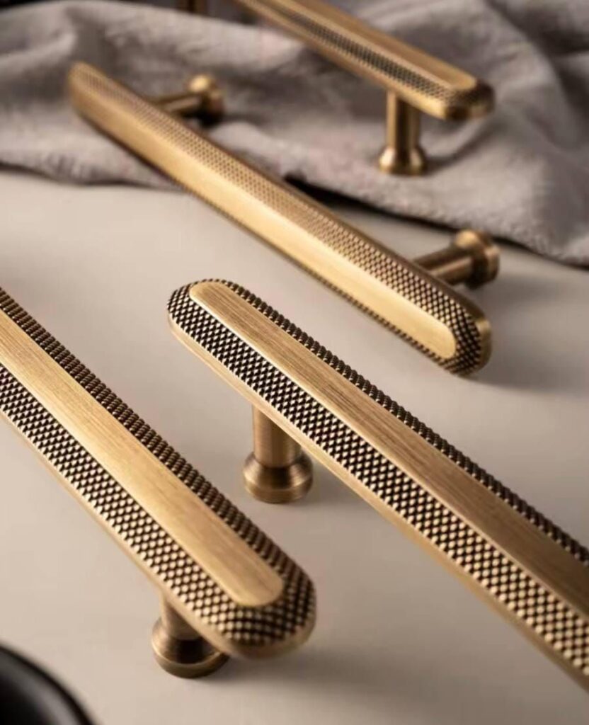 58c4db947066c0308470c48af6cacf0b Gold textured cabinet handles on a smooth surface, highlighting modern design and elegant craftsmanship. | Sky Rye Design Gold textured cabinet handles on a smooth surface, highlighting modern design and elegant craftsmanship.