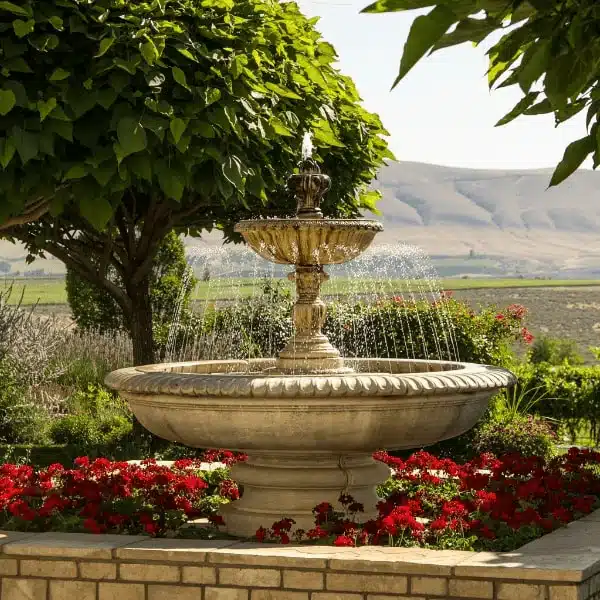 5b07b42a01bffe10ec60f5a28ae9fa35-915397 Elegant garden fountain surrounded by red flowers and lush greenery under a clear blue sky. | Sky Rye Design Elegant garden fountain surrounded by red flowers and lush greenery under a clear blue sky.
