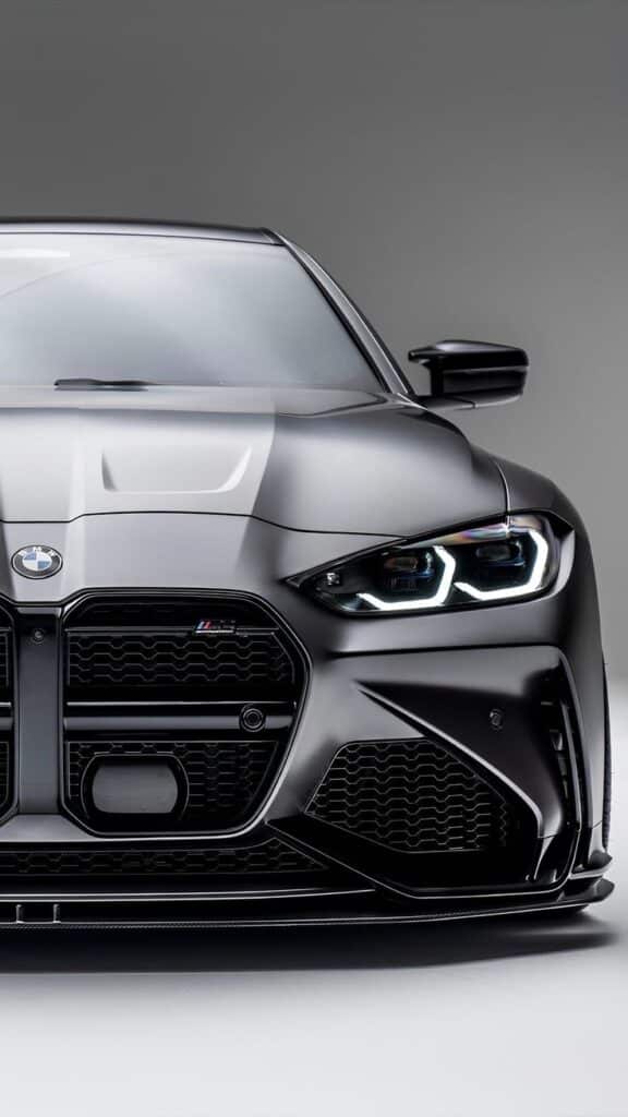 Sleek black BMW car featuring stylish headlights and a bold grille design, showcasing luxury and modern automotive design.