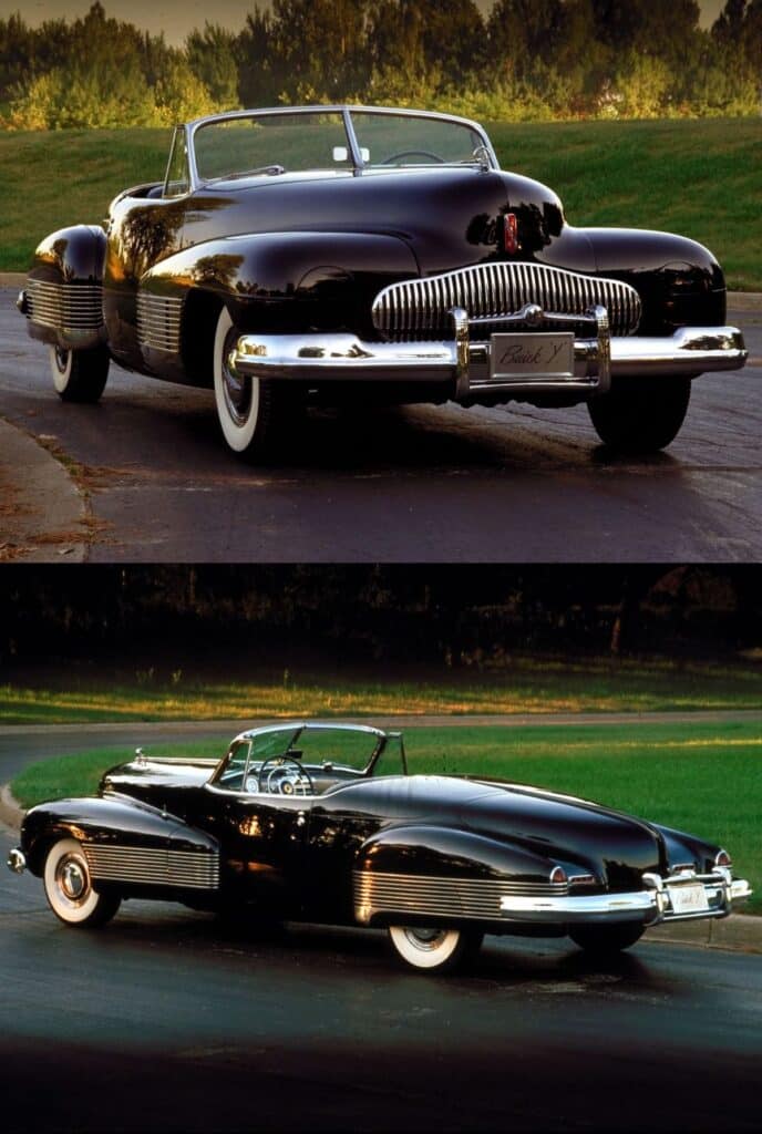 Vintage black convertible car with classic chrome details parked on a road, surrounded by greenery.