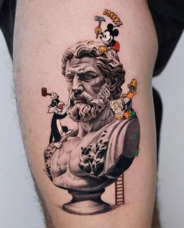 Tattoo of a classical bust surrounded by cartoon characters on a person's leg.