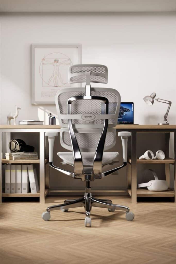 61f41e6ed72c0c7ed9c8476e88a68e63 Ergonomic mesh office chair in modern home workspace, featuring a desk with computer, books, and desk lamp. | Sky Rye Design Ergonomic mesh office chair in modern home workspace, featuring a desk with computer, books, and desk lamp.