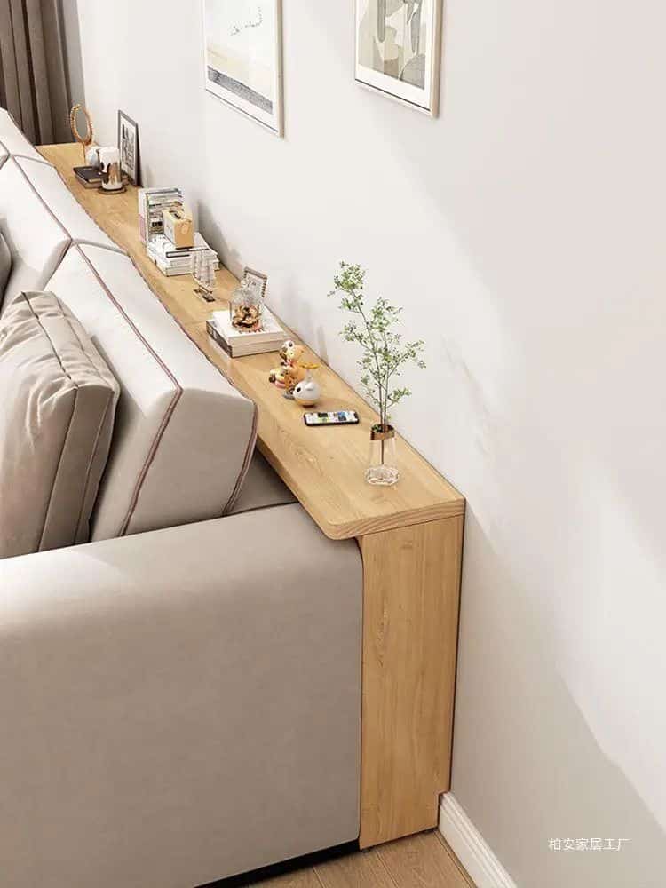 62294c3d4a7cd5fc6bd2702bc0cf89ba Modern sofa with a sleek wooden tabletop featuring decor, books, and a small plant for a cozy living space. | Sky Rye Design Modern sofa with a sleek wooden tabletop featuring decor, books, and a small plant for a cozy living space.