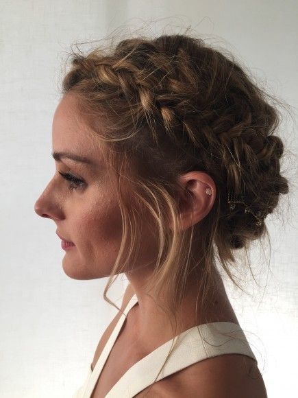 Profile view of woman with elegant updo hairstyle, featuring intricate braids and loose strands, ideal for formal occasions.