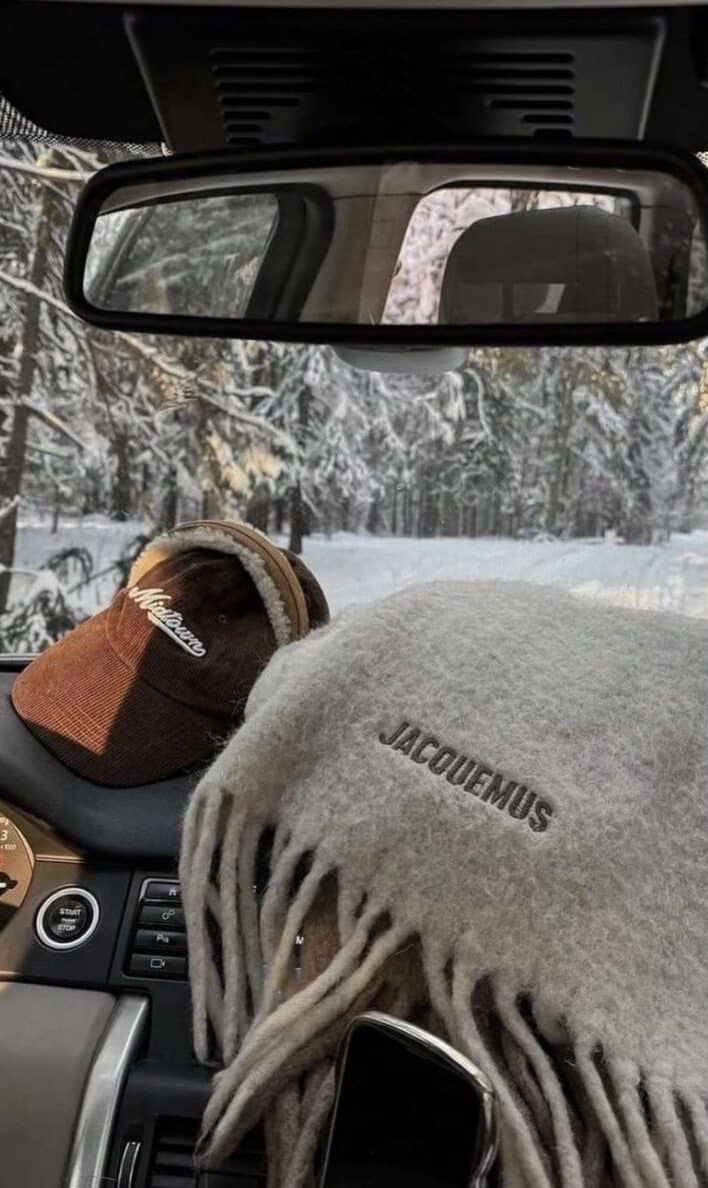 Screenshot Car dashboard with winter cap and scarf, snowy forest view through window, cozy winter drive vibes. | Sky Rye Design Car dashboard with winter cap and scarf, snowy forest view through window, cozy winter drive vibes.