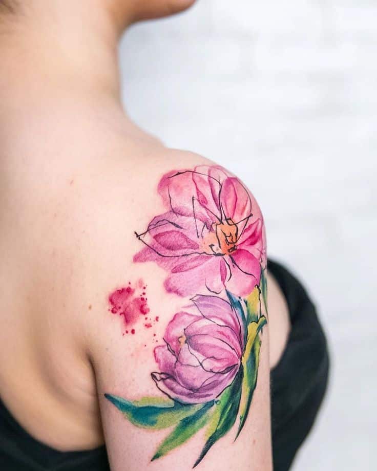 6e4a9517-b539-42b0-aa97-8c9bad0dcfa6 Watercolor-style pink flower tattoo on a person's shoulder, featuring vibrant petals and green leaves. | Sky Rye Design Watercolor-style pink flower tattoo on a person's shoulder, featuring vibrant petals and green leaves.