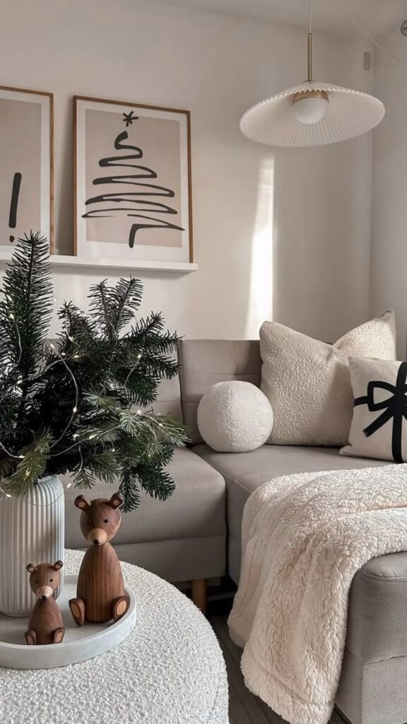 6ef16131-d8c6-4462-921a-9b273a7de976 Cozy living room with modern Christmas decor, wooden bears, plush pillows, and framed tree art. | Sky Rye Design Cozy living room with modern Christmas decor, wooden bears, plush pillows, and framed tree art.