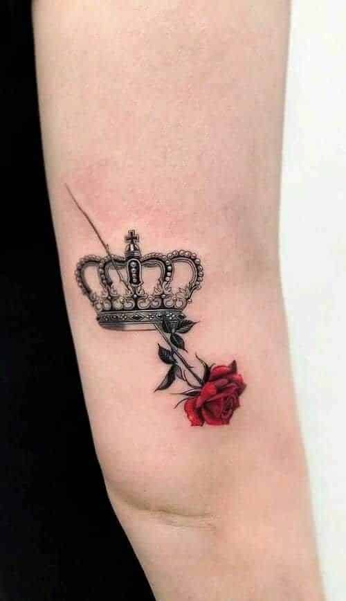 _ 7 Arm tattoo featuring a detailed crown and a vibrant red rose, symbolizing strength and beauty intertwined. | Sky Rye Design Arm tattoo featuring a detailed crown and a vibrant red rose, symbolizing strength and beauty intertwined.