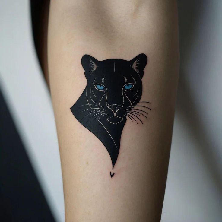 Stylish black panther tattoo with blue eyes on forearm, showcasing elegant and bold design.