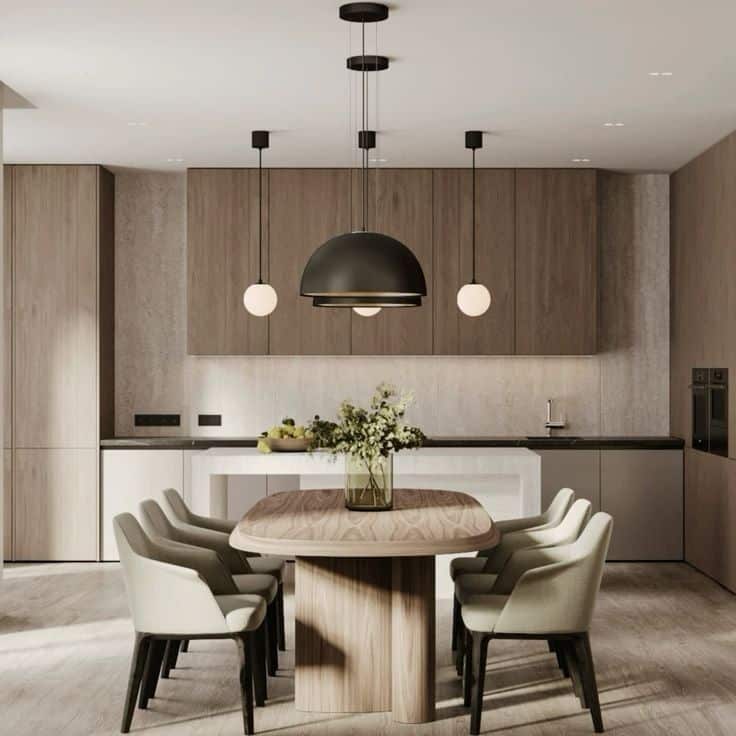 Modern kitchen interior with wooden cabinets, sleek dining table, green chairs, and hanging pendant lights.